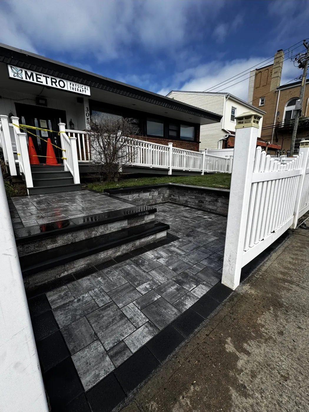 Commercial paver entrance with charcoal paver steps and black granite treads at a physical therapy office on Long Island NY